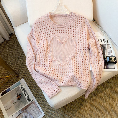 A unique and elegant knitted sweater with openwork heart design.