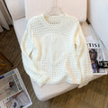 A unique and elegant knitted sweater with openwork heart design.