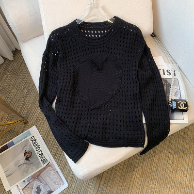 A unique and elegant knitted sweater with openwork heart design.